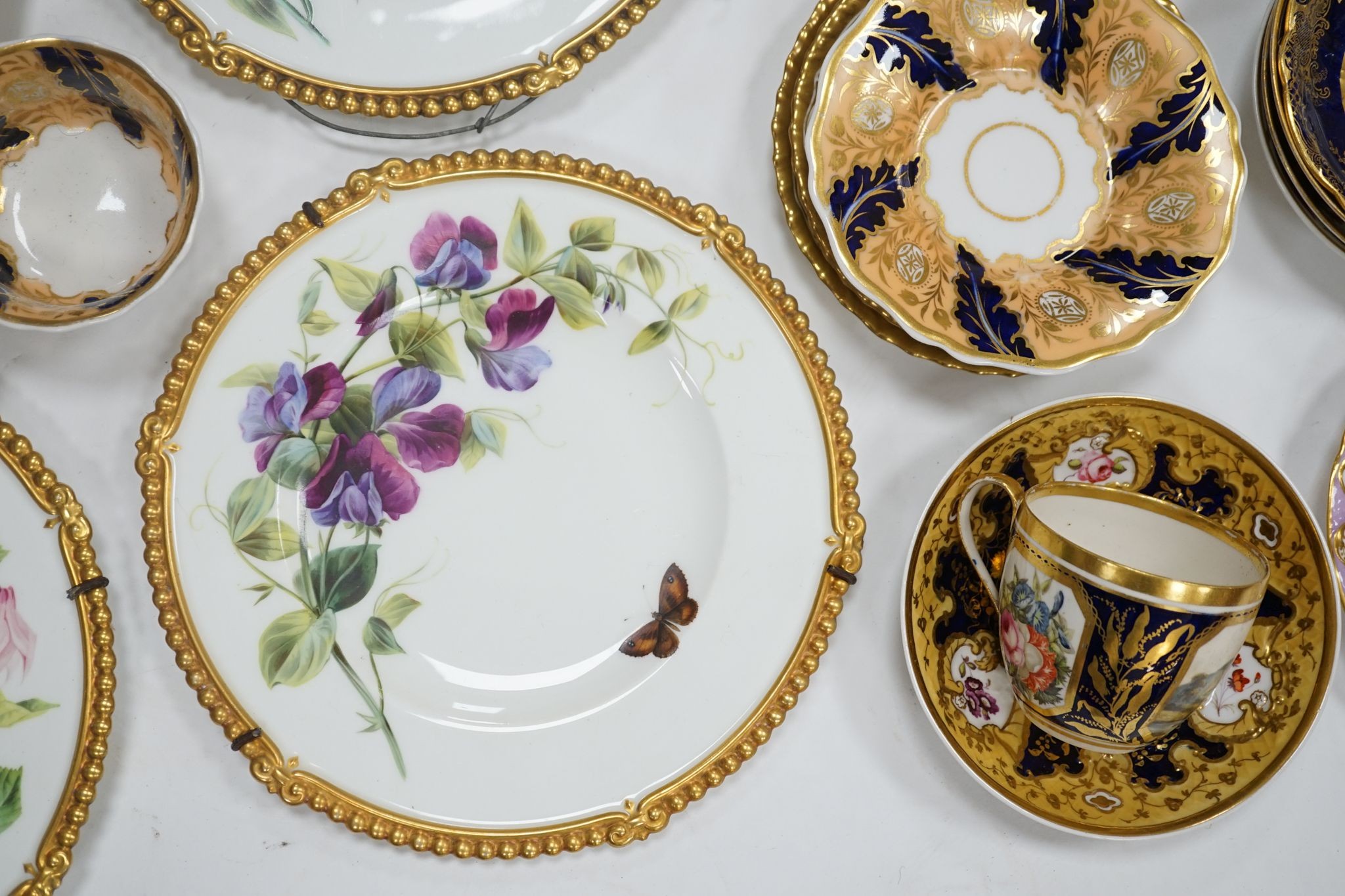 A small collection of Victorian porcelain tea cups and saucers and sundry dessert plates